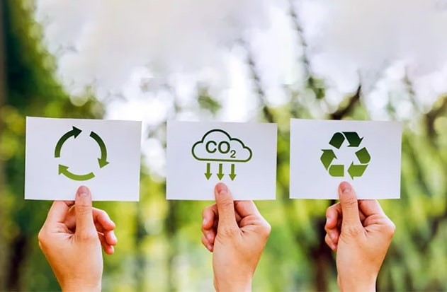 Three hands are depicted, each displaying an icon symbolizing sustainability.
