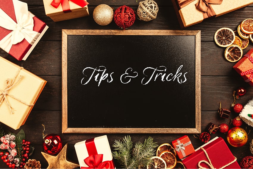 Frame with the word 'Tips and Tricks' written, around Christmas gifts and decorations