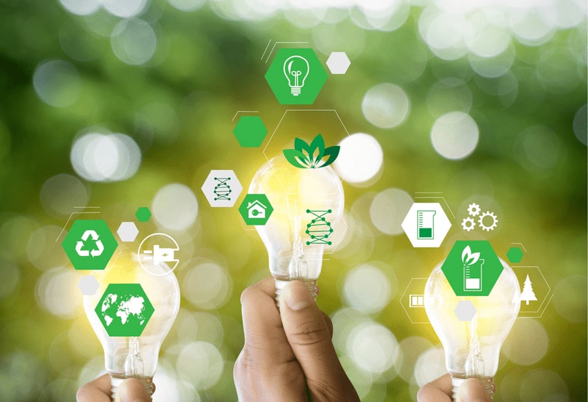 Three light bulbs held by hands surrounded by sustainability icons