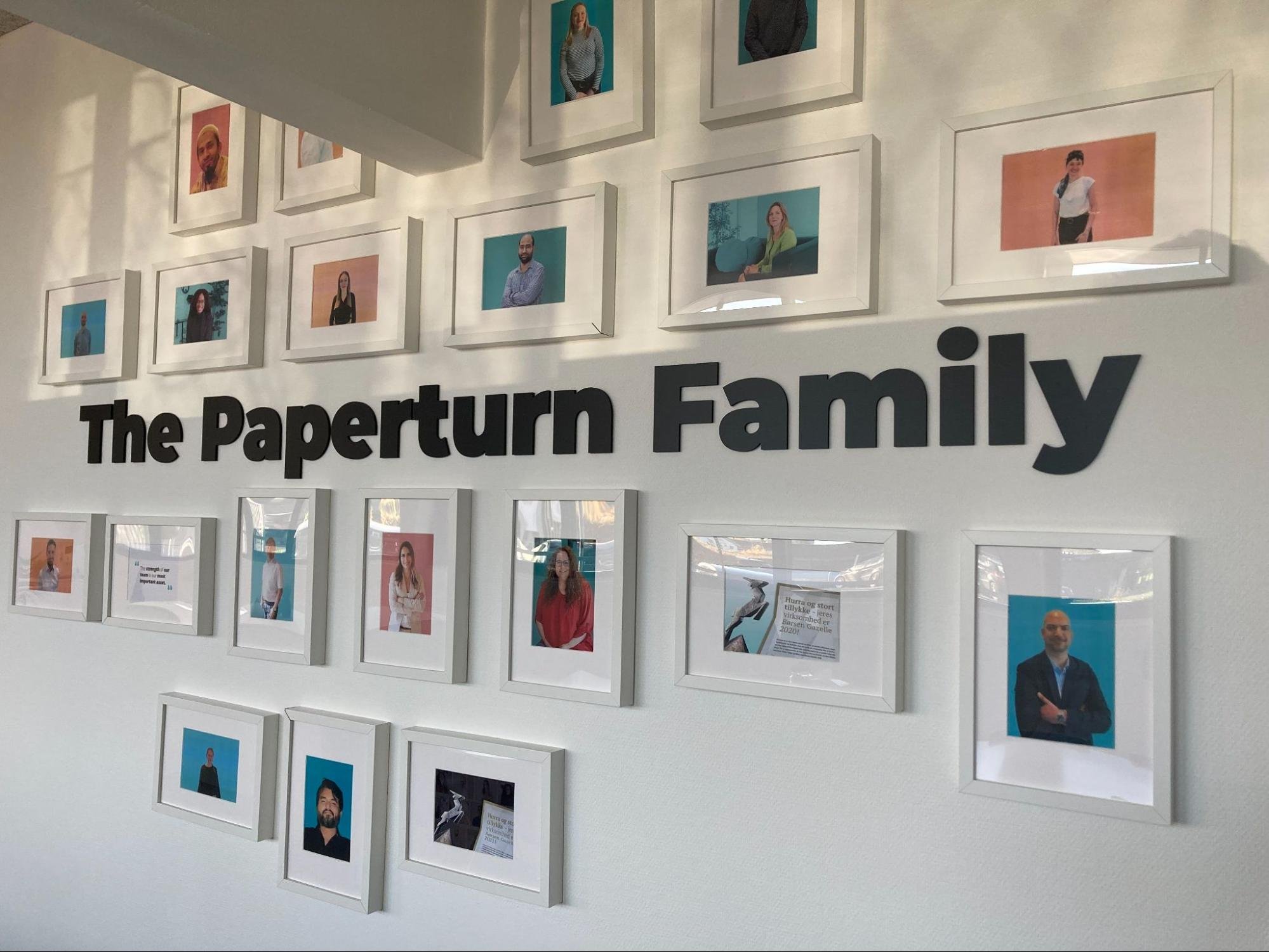 White wall with pictures of the Paperturn family