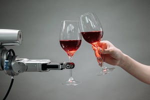 A hand a robot hand holding wine glasses. Credit: Pavel Danilyuk.
