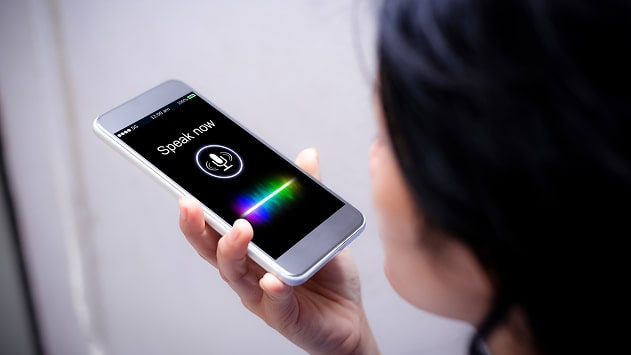 A person using a smartphone for voice search. A person using a smartphone for voice search.