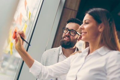 Business people planning strategy writing on post-its