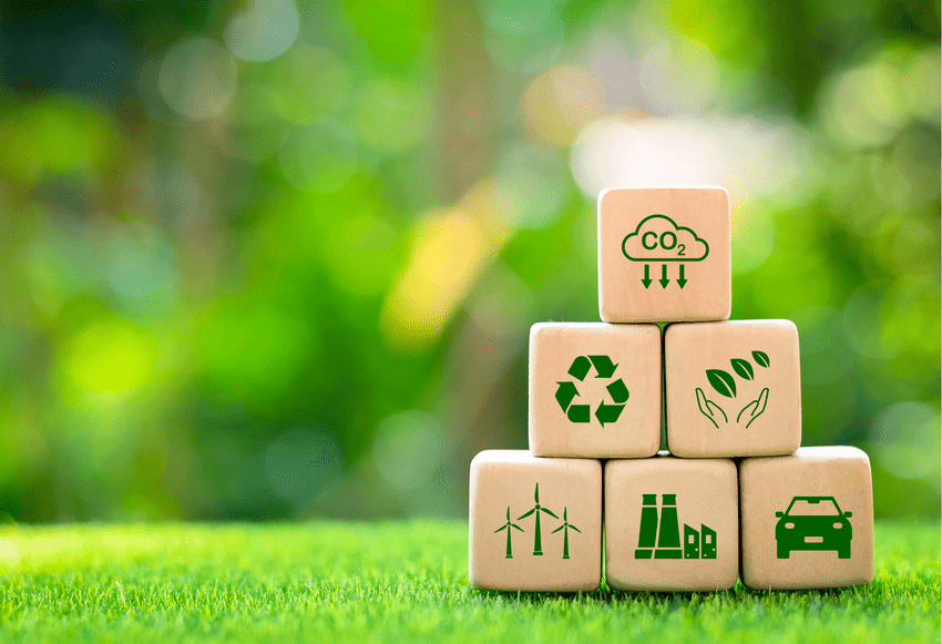 Wooden building blocks with sustainability symbols on them